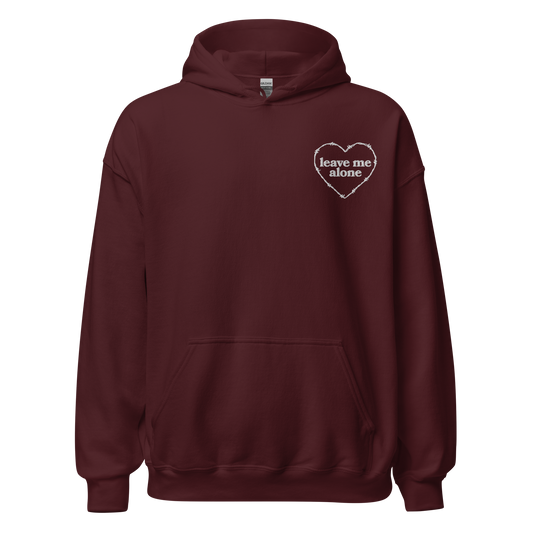 Maroon hooded sweatshirt that has a barbed wire heart and the phrase "leave me alone" embroidered on the left breast
