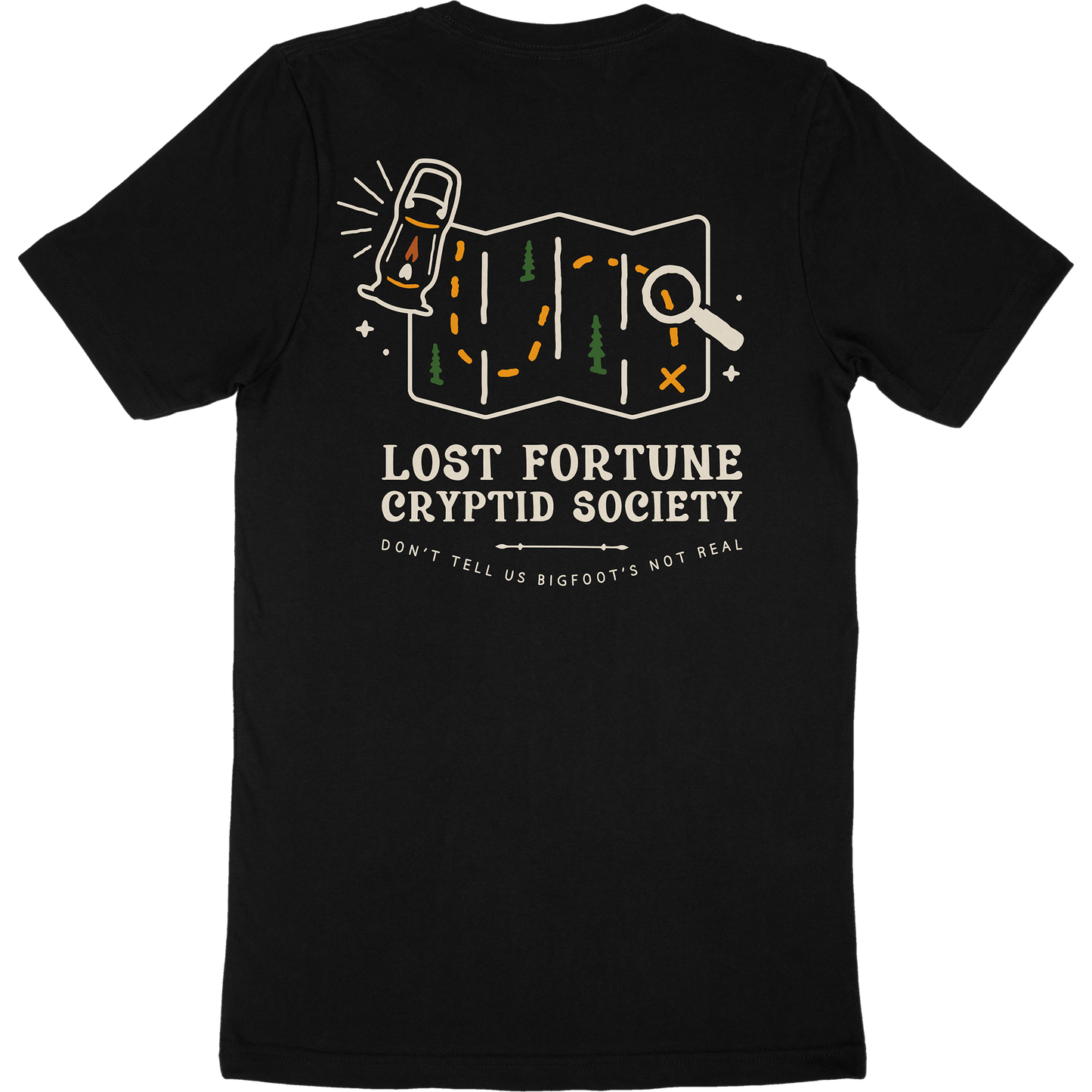 Black t-shirt that has a map and lantern artwork. The words say "Lost Fortune Cryptid Society," and "don't tell us bigfoot's not real."