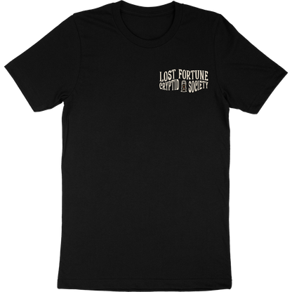 Black t-shirt that says "Lost Fortune Cryptid Society" on the front left breast. There is a lantern icon between "cryptid" and "society."