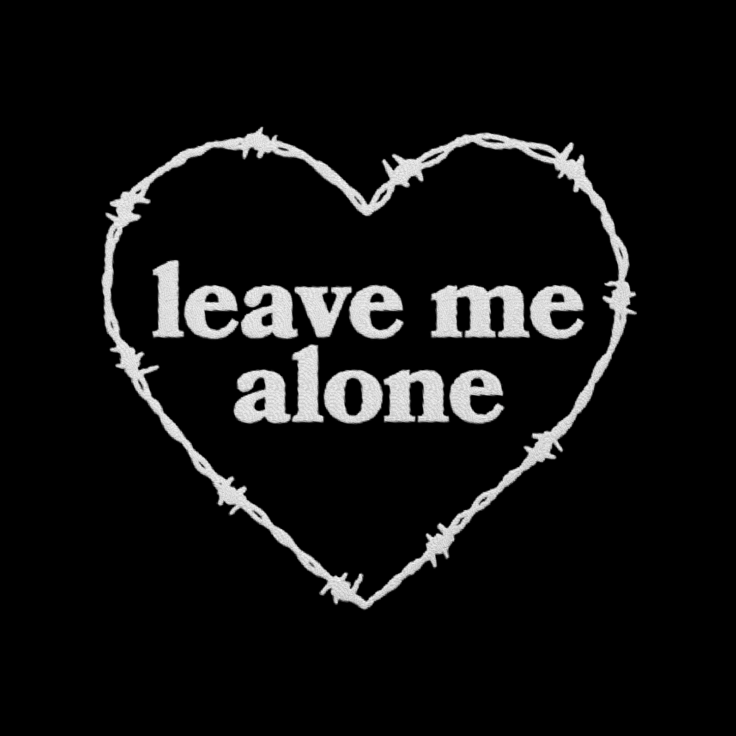 Artwork of a barbed wire heart surrounding the words "leave me alone"